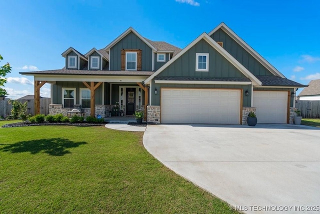 craftsman house featuring board and batten siding, driveway, covered porch, and stone siding
