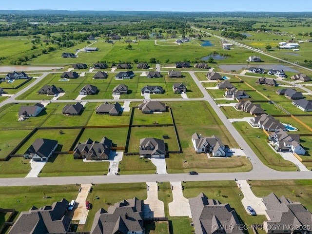 bird's eye view with a water view and a residential view