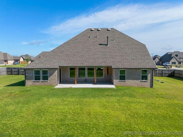 back of house featuring brick siding, a patio, and a fenced backyard