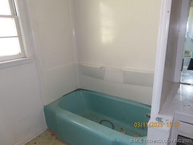 bathroom with a tub