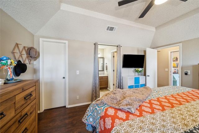 bedroom featuring lofted ceiling, dark wood-style floors, visible vents, and a textured ceiling