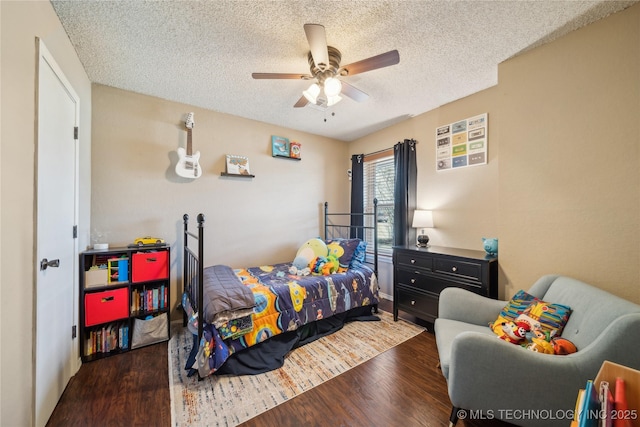 bedroom featuring ceiling fan, a textured ceiling, and wood finished floors