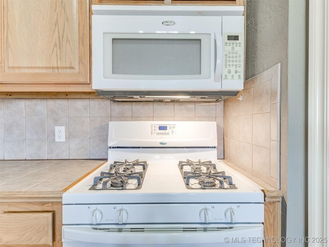 kitchen with white appliances, light countertops, decorative backsplash, and light brown cabinetry