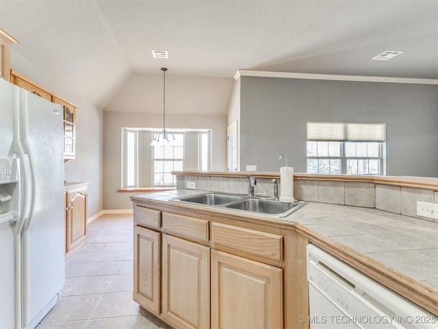 kitchen featuring tile counters, visible vents, light brown cabinets, a sink, and white appliances