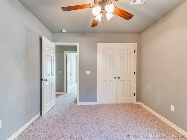 unfurnished bedroom featuring a closet, light carpet, visible vents, and baseboards