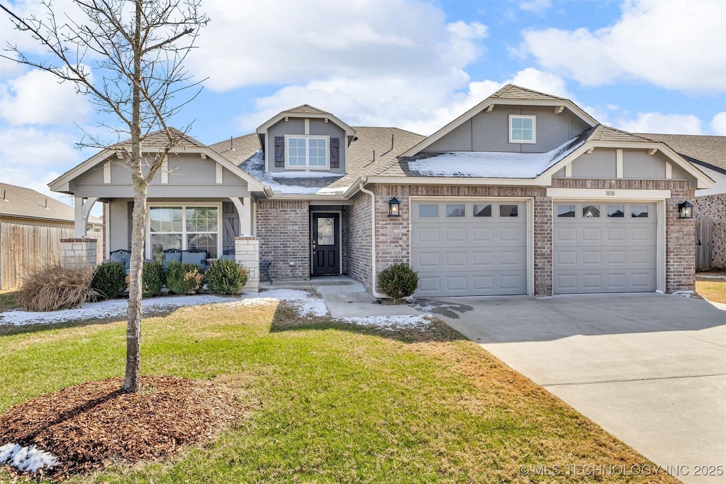 craftsman inspired home featuring driveway, a garage, fence, a front lawn, and brick siding