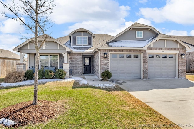 craftsman inspired home featuring driveway, a garage, fence, a front lawn, and brick siding