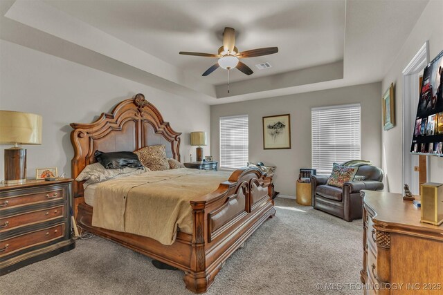 3838 E 144th St S, Bixby, OK 74008 - bedroom featuring carpet floors, a tray ceiling, and ceiling fan