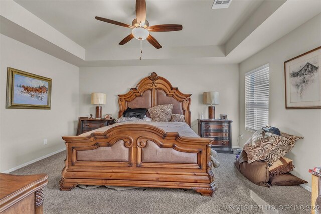 3838 E 144th St S, Bixby, OK 74008 - carpeted bedroom with a tray ceiling and ceiling fan