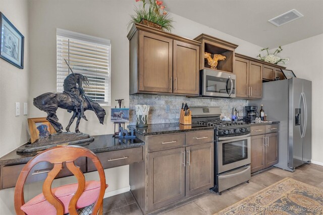 3838 E 144th St S, Bixby, OK 74008 - kitchen featuring appliances with stainless steel finishes, tasteful backsplash, open shelves, and dark stone counters