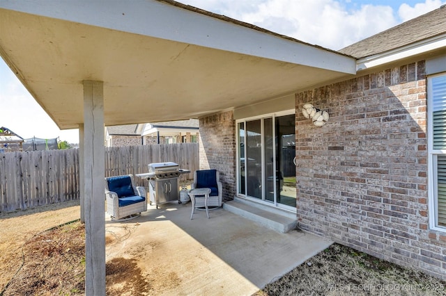 view of patio / terrace featuring grilling area and fence