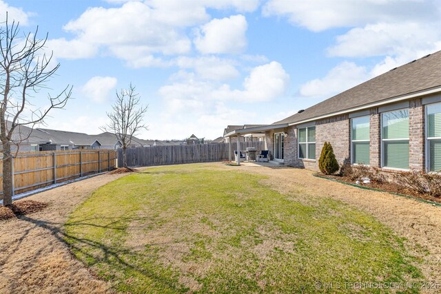 3838 E 144th St S, Bixby, OK 74008 - fenced backyard with a patio