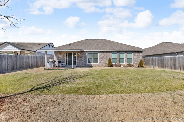 3838 E 144th St S, Bixby, OK 74008 - rear view of property featuring brick siding, a fenced backyard, a patio, and roof with shingles