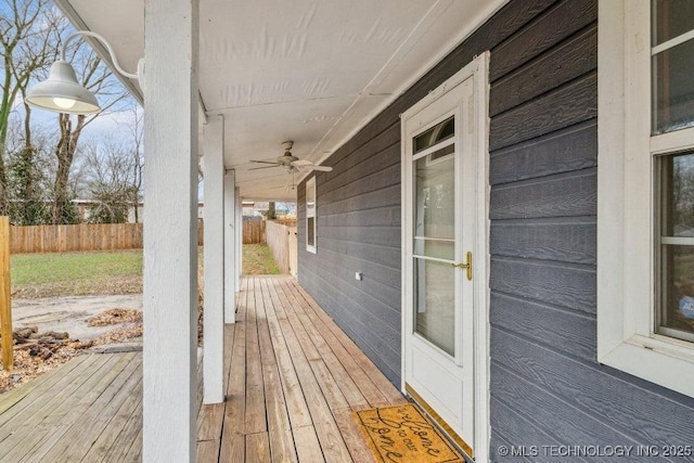 wooden terrace featuring fence