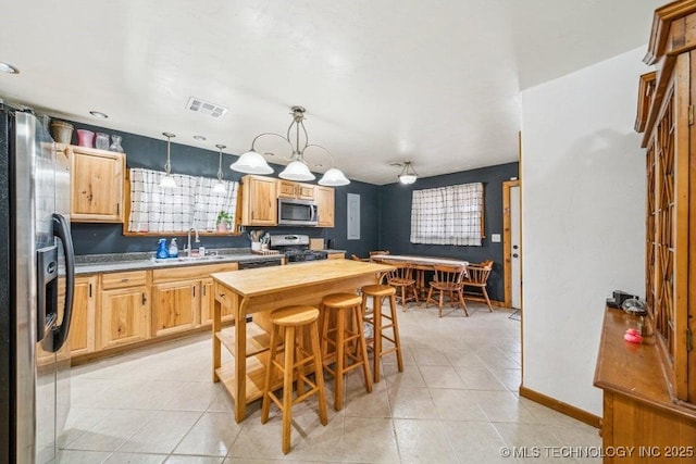 kitchen featuring light tile patterned floors, visible vents, appliances with stainless steel finishes, and a sink