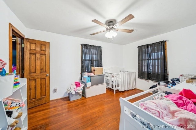 bedroom with ceiling fan and wood finished floors