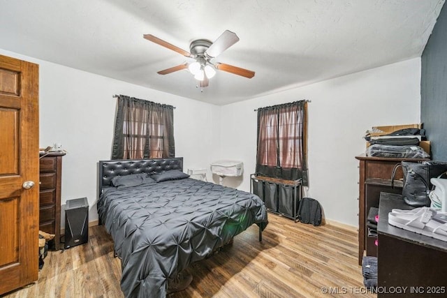 bedroom with light wood finished floors and ceiling fan