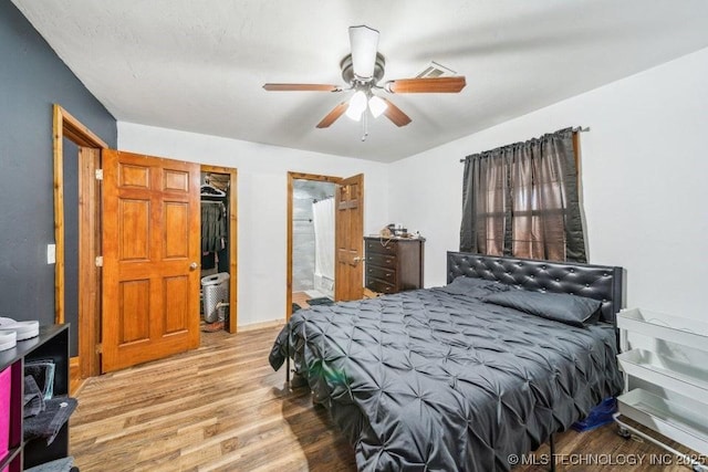 bedroom with a ceiling fan and wood finished floors