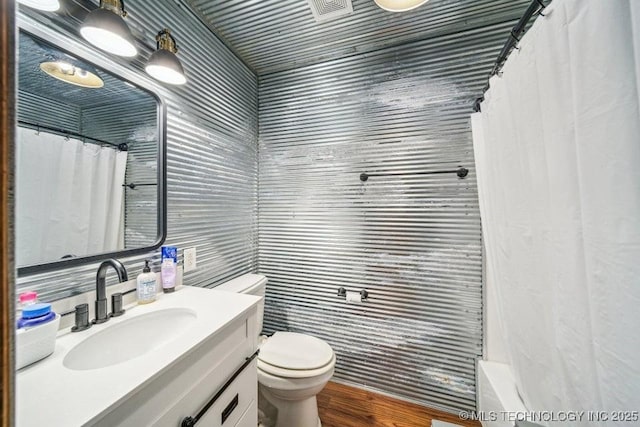 bathroom featuring a shower with shower curtain, vanity, and toilet