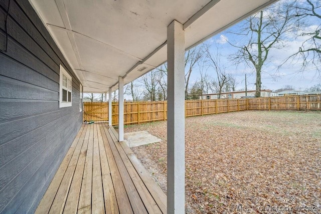 deck with a fenced backyard