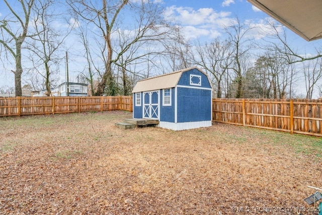 view of yard with a fenced backyard, an outdoor structure, and a storage shed