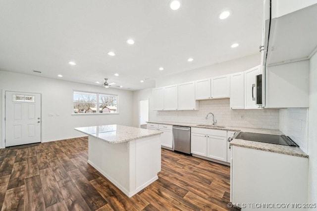 kitchen with a sink, a center island, dishwasher, dark wood finished floors, and backsplash
