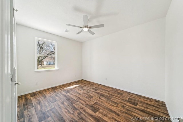 517 W Clyde Ave, Vinita, OK 74301 - spare room featuring dark wood finished floors, a ceiling fan, and baseboards