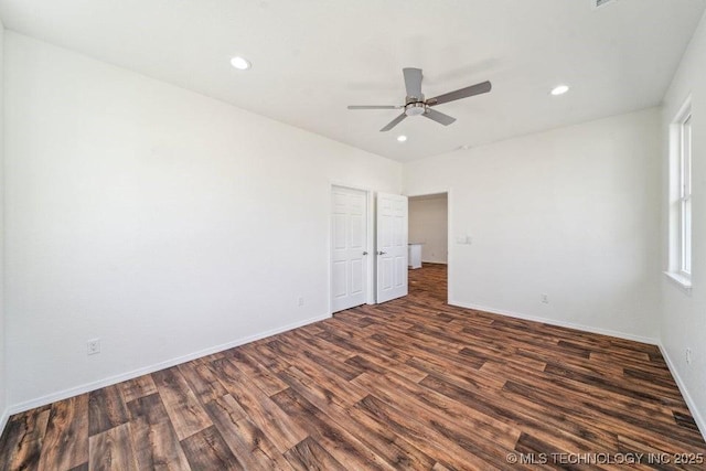 spare room featuring recessed lighting, a ceiling fan, dark wood-style floors, and baseboards