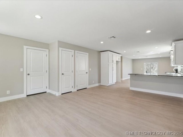 4613 S Linwood Dr, Sand Springs, OK 74063 - unfurnished living room with light wood finished floors, recessed lighting, visible vents, and baseboards