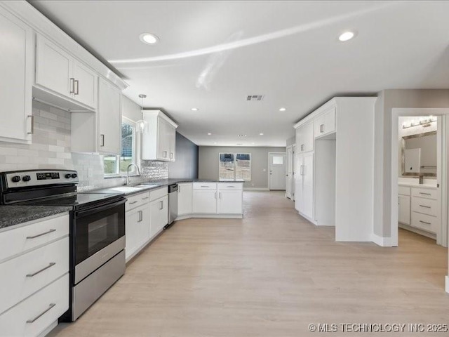 4613 S Linwood Dr, Sand Springs, OK 74063 - kitchen featuring light wood finished floors, decorative backsplash, a peninsula, stainless steel appliances, and a sink