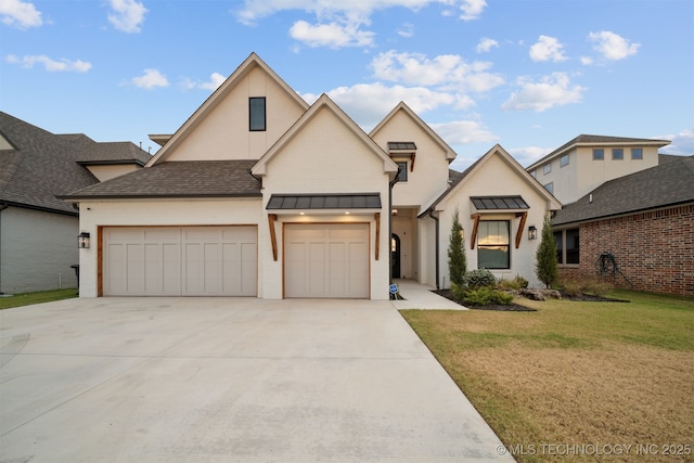 view of front of house featuring metal roof, an attached garage, concrete driveway, a front lawn, and a standing seam roof