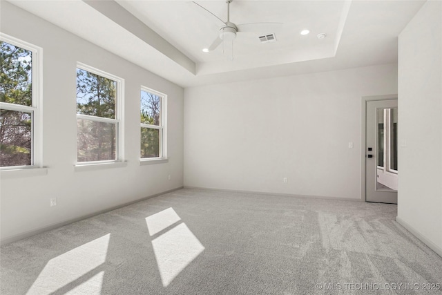 empty room featuring a ceiling fan, baseboards, carpet floors, a tray ceiling, and recessed lighting