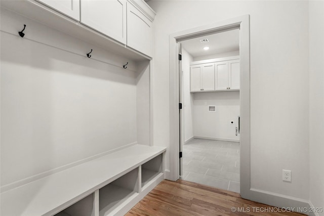 mudroom featuring light wood-type flooring and baseboards