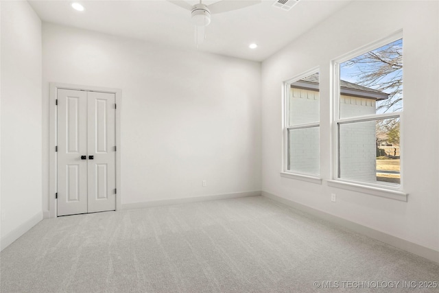 carpeted empty room featuring visible vents, recessed lighting, and baseboards