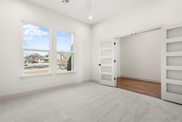 unfurnished bedroom featuring recessed lighting, visible vents, baseboards, and carpet flooring