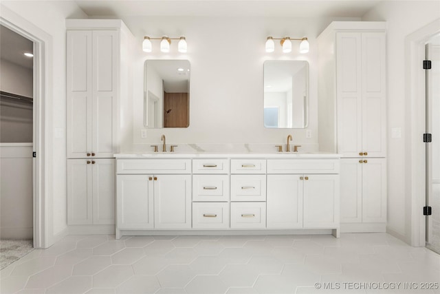 bathroom featuring double vanity, a closet, tile patterned floors, and a sink