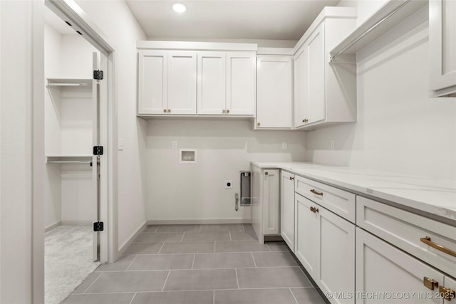 clothes washing area featuring baseboards, washer hookup, recessed lighting, cabinet space, and electric dryer hookup