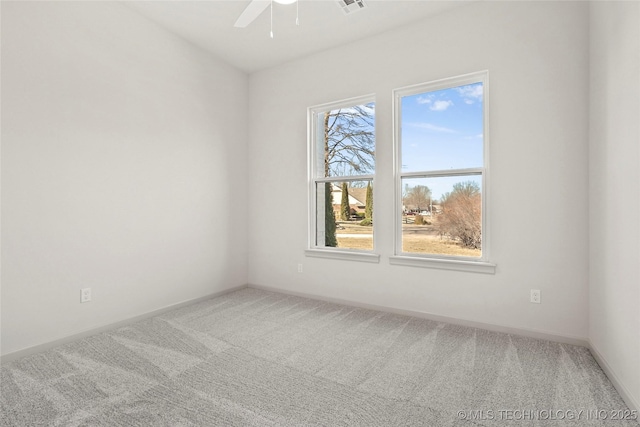 spare room featuring visible vents, baseboards, a ceiling fan, and carpet flooring