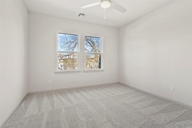 empty room with visible vents, ceiling fan, baseboards, and carpet