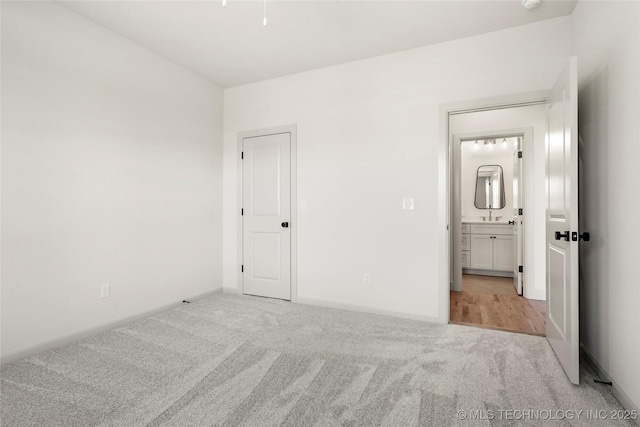 unfurnished bedroom with carpet flooring and baseboards