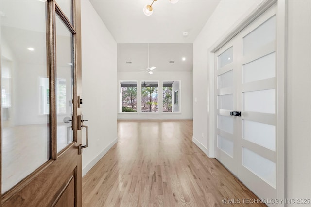 entryway with light wood-type flooring and baseboards