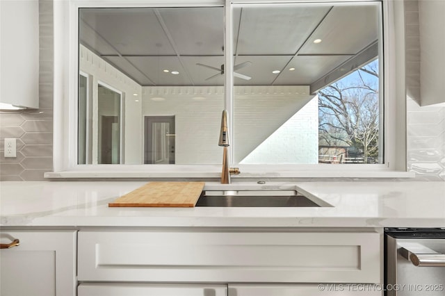 kitchen featuring recessed lighting, light stone countertops, ceiling fan, and white cabinetry