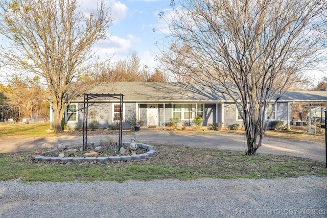 single story home featuring aphalt driveway