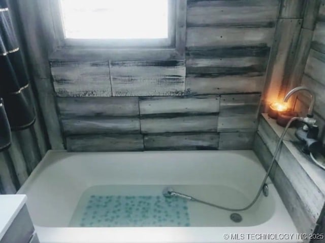 bathroom with a washtub and a shower