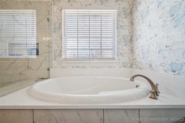 bathroom with a bath and a healthy amount of sunlight