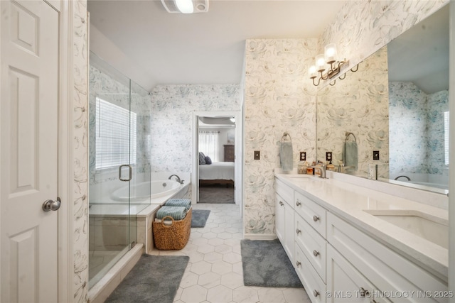 full bathroom with tile patterned flooring, connected bathroom, a sink, a shower stall, and wallpapered walls