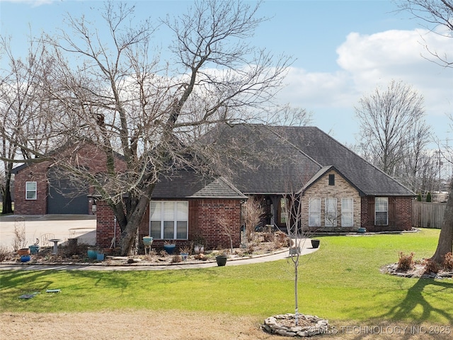 view of front of property featuring a front yard, brick siding, fence, and roof with shingles