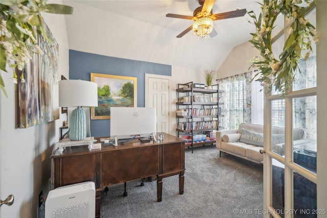 office area featuring vaulted ceiling, carpet flooring, and a ceiling fan