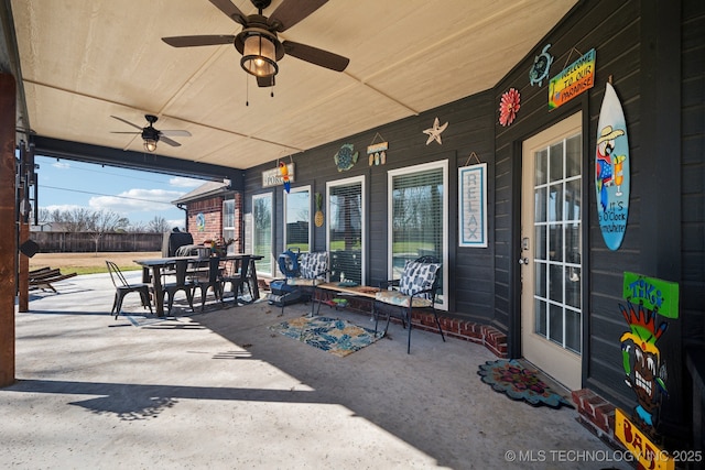view of patio / terrace featuring a ceiling fan, outdoor dining space, and covered porch