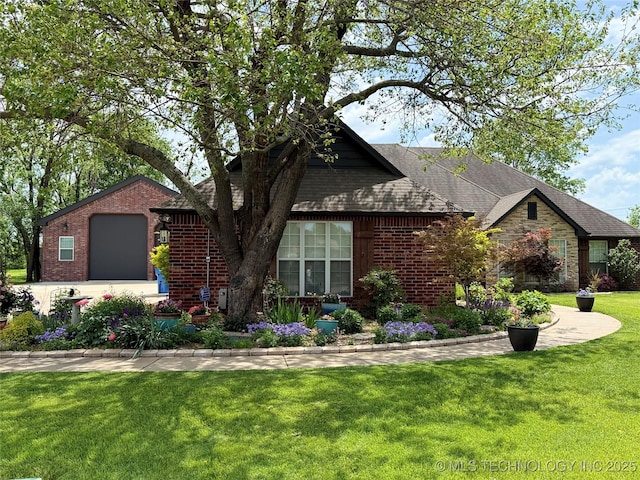 view of front of house with brick siding, a shingled roof, a front lawn, and a garage